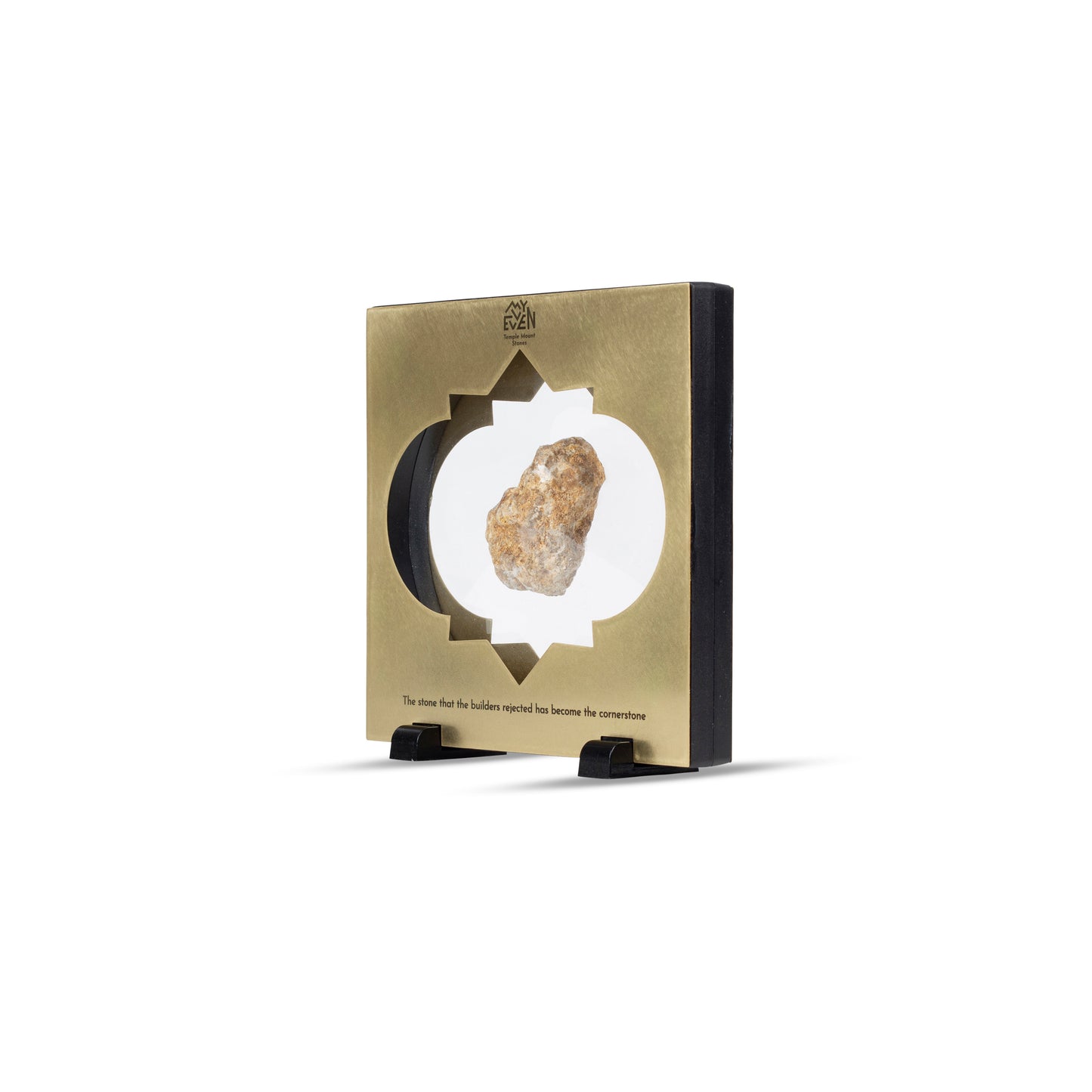 A side view of a natural stone suspended in the middle of a square bronze frame with a traditional middle eastern inlay that is set on two little black square stands. On the top of the frame is the "MyEvven" logo that says Temple Mount Stones below it. On the bottom of the frame, it reads "The stone that the builders rejected has become the cornerstone".